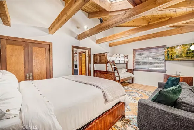 a large bed sitting in a bedroom next to a window