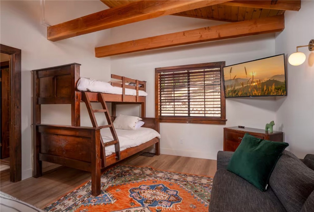 764 Fern Road Lake Arrowhead, CA 92385 - Photo 27 of 60 a bedroom with a bed and wooden floor