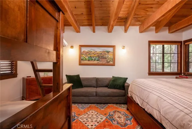 a living room with pool table and wooden floor
