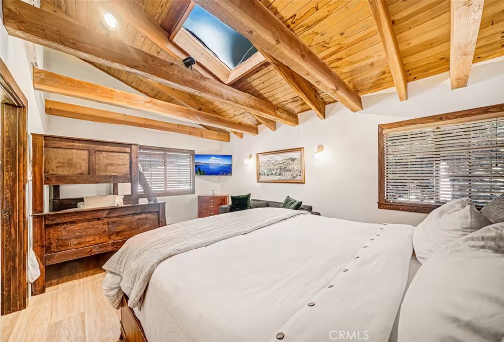 764 Fern Road Lake Arrowhead, CA 92385 - Photo 29 of 60 a large bed sitting in a bedroom next to a window
