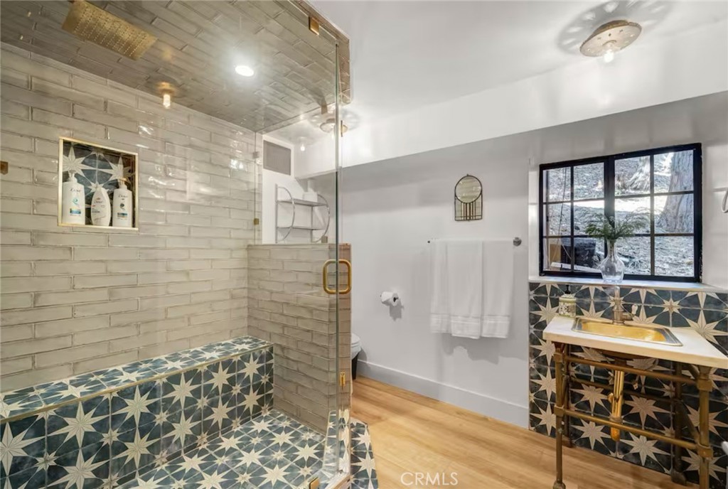 764 Fern Road Lake Arrowhead, CA 92385 - Photo 37 of 60 a bathroom with a sink a mirror and a shower