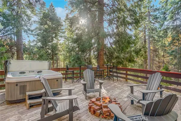 a kitchen with stainless steel appliances a stove a sink dishwasher a refrigerator white cabinets and wooden floor