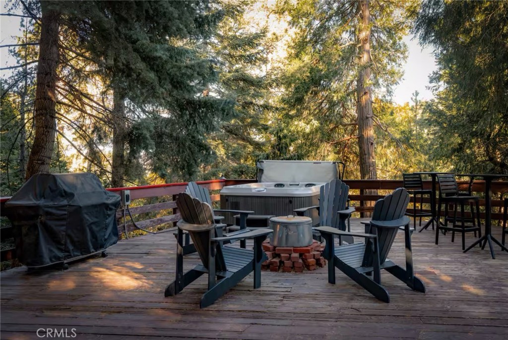 764 Fern Road Lake Arrowhead, CA 92385 - Photo 4 of 60 a view of a dinning tables and chairs in a patio