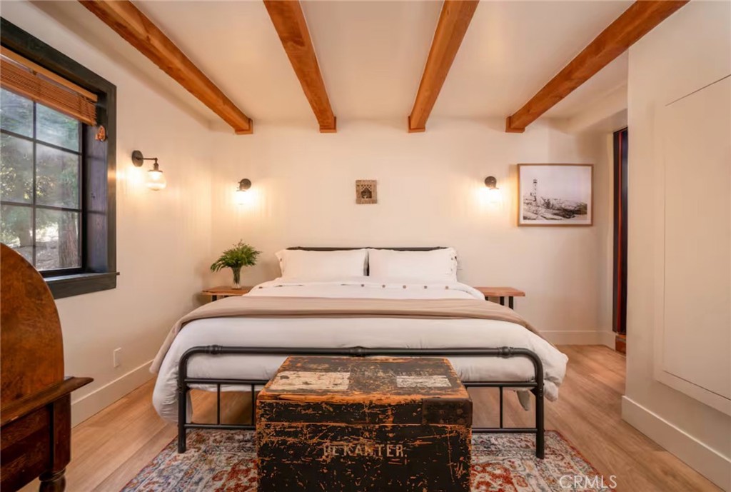 764 Fern Road Lake Arrowhead, CA 92385 - Photo 44 of 60 a bedroom with a bed and wooden floor