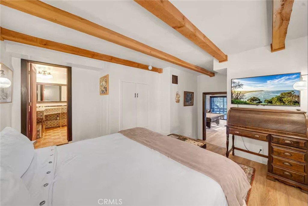 764 Fern Road Lake Arrowhead, CA 92385 - Photo 46 of 60 a bedroom with a bed and wooden floor