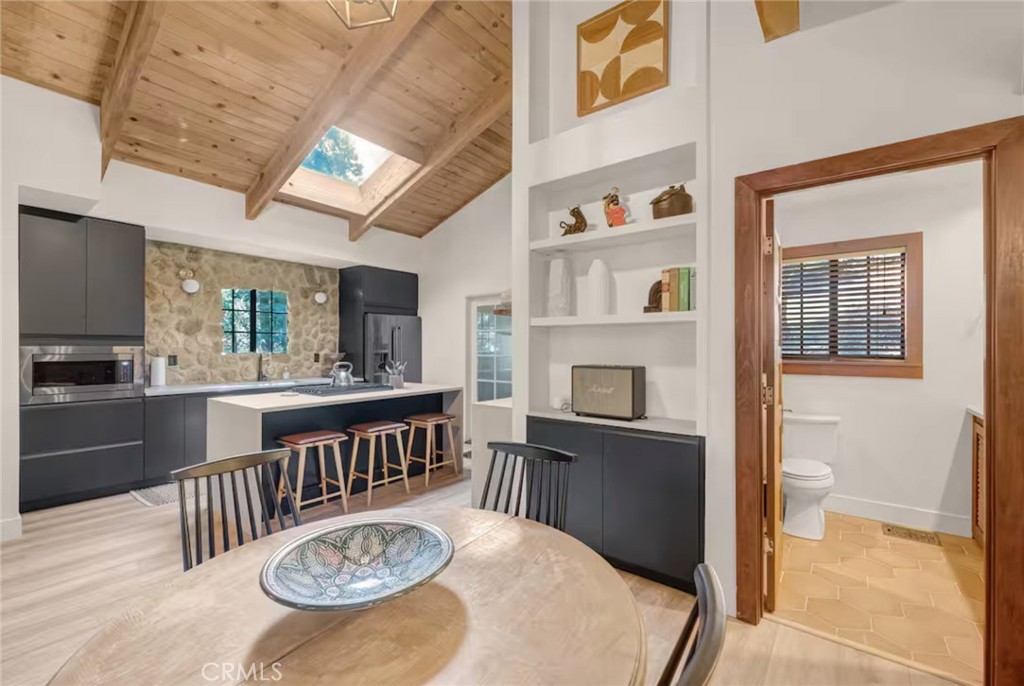 764 Fern Road Lake Arrowhead, CA 92385 - Photo 5 of 60 a view of a dining room with furniture