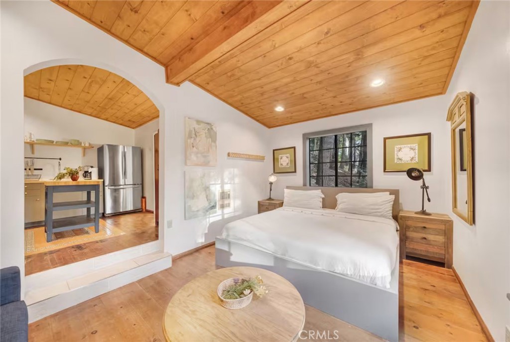 764 Fern Road Lake Arrowhead, CA 92385 - Photo 53 of 60 a large bedroom with a large bed and wooden floor