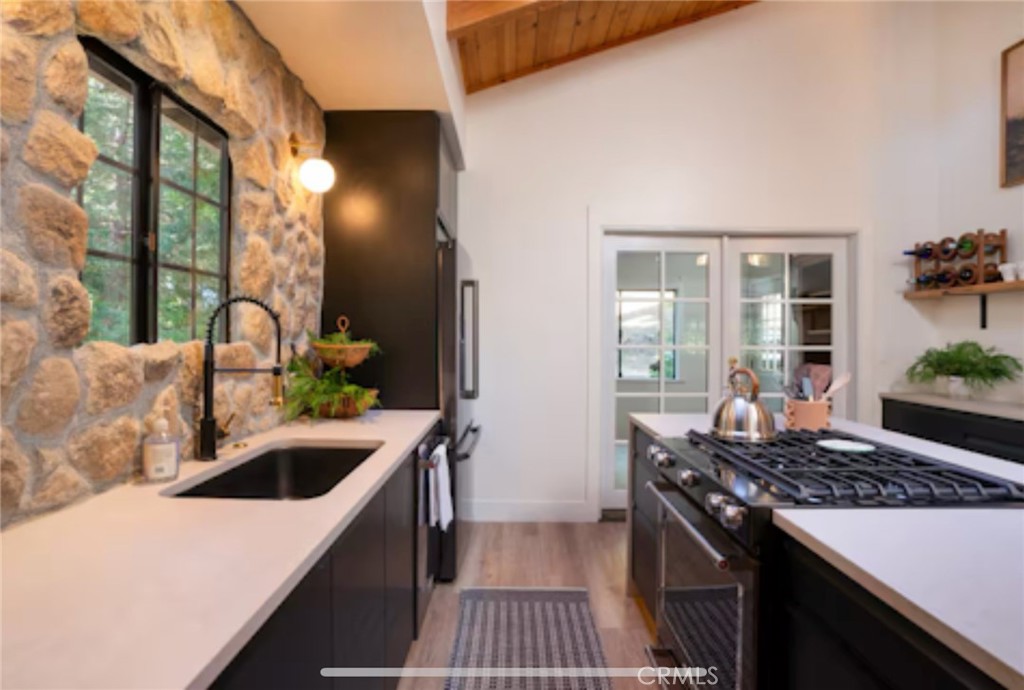 764 Fern Road Lake Arrowhead, CA 92385 - Photo 7 of 60 a kitchen that has a sink and a stove