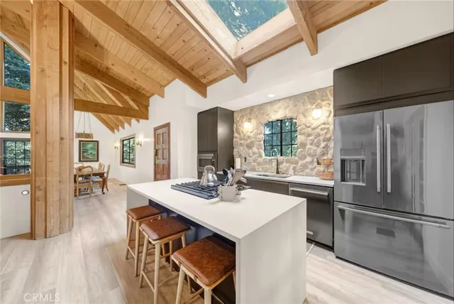 a kitchen with stainless steel appliances a stove a sink and a refrigerator