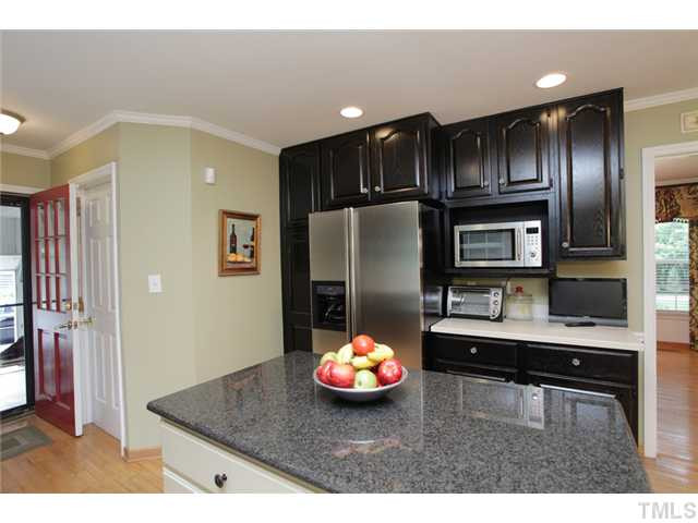 220 Bayleaf Drive Raleigh, NC 27615 - Photo 8 of 25 The black cabinetry with the cream island as an accent make this kitchen very dramatic and stylish. It even has a pantry! Kitchen