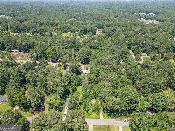 an aerial view of a house with yard