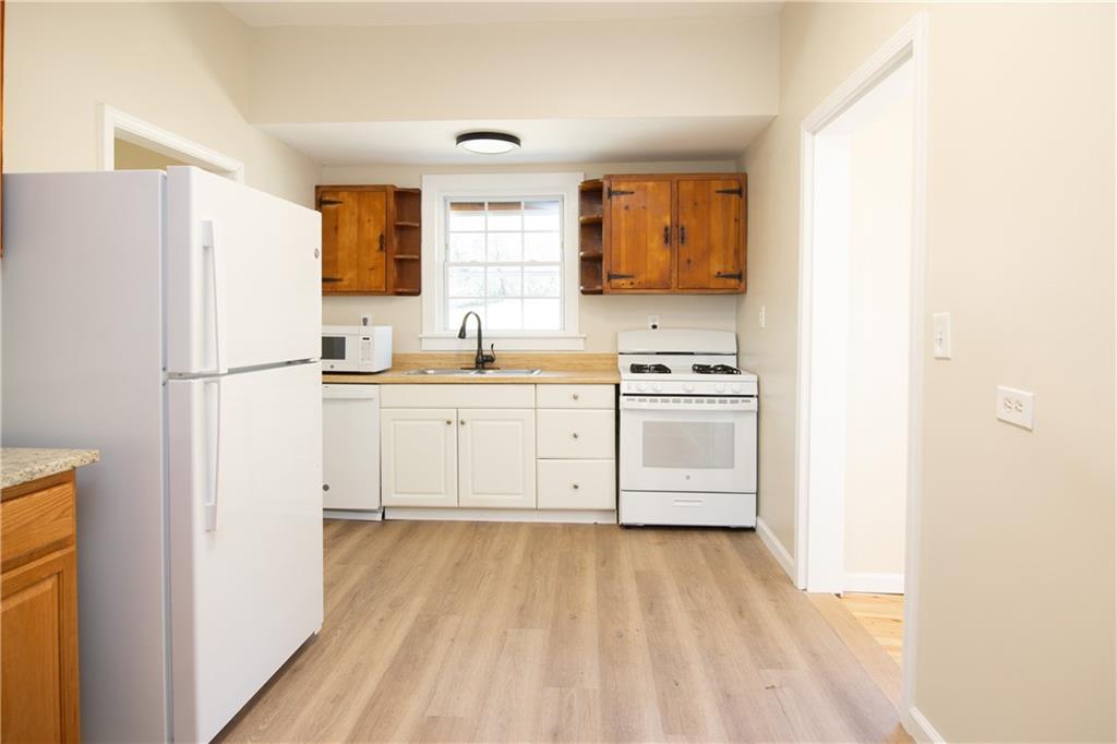 163 Rabbit Town Road Tate, GA 30177 - Photo 14 of 32 a kitchen with a sink a refrigerator a stove and a window