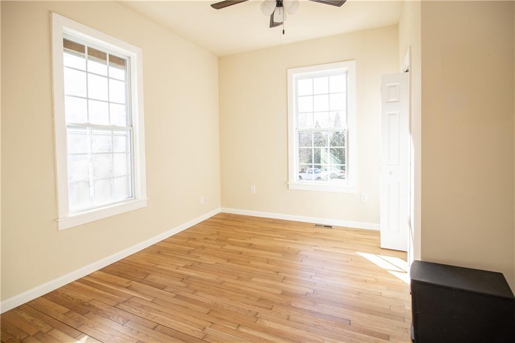 163 Rabbit Town Road Tate, GA 30177 - Photo 18 of 32 an empty room with wooden floor and windows