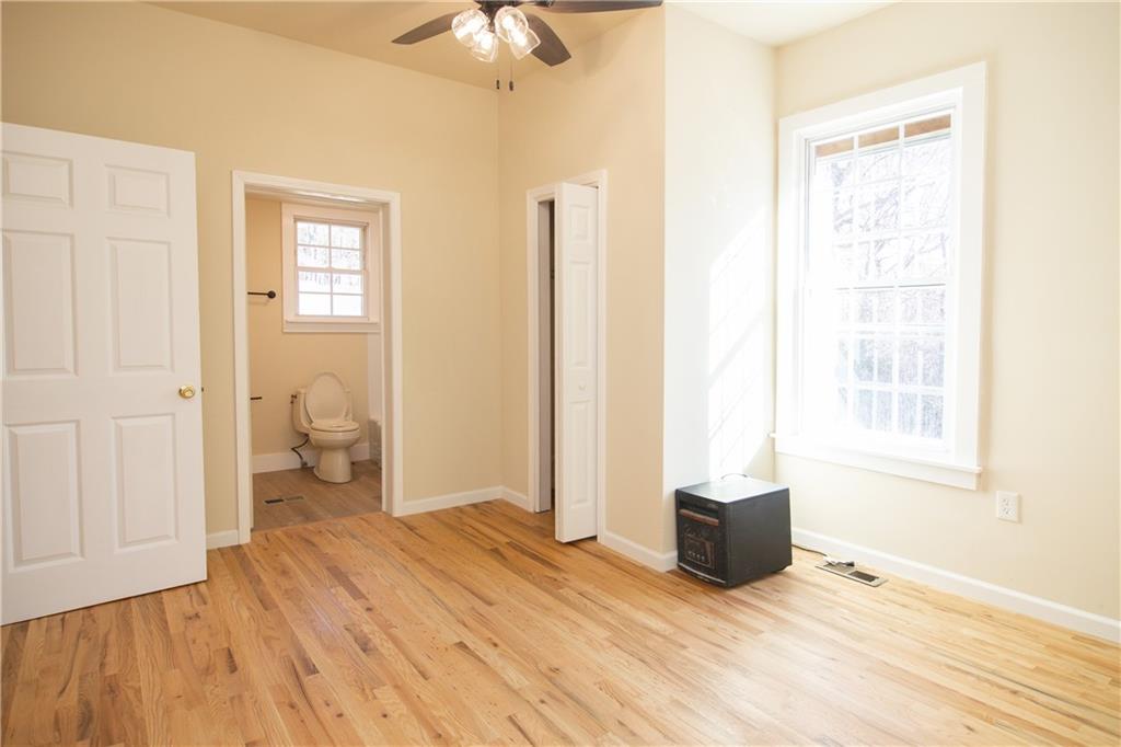 163 Rabbit Town Road Tate, GA 30177 - Photo 23 of 32 a bedroom with a bed and a chandelier
