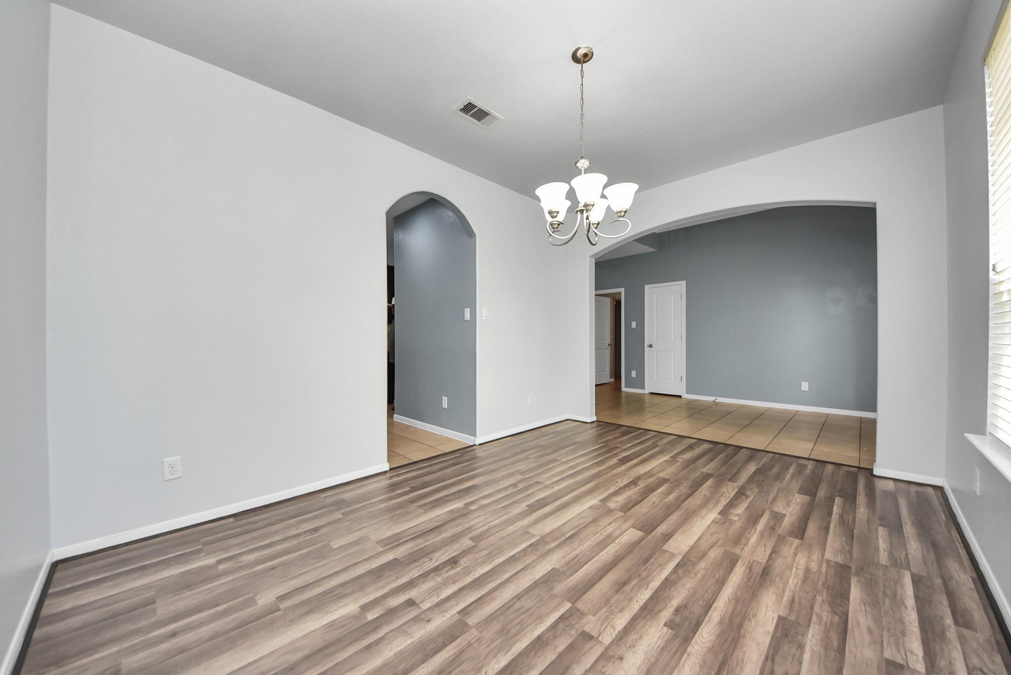 33227 Greenfield Forest Drive Spring, TX 77382 - Photo 14 of 50 a view of livingroom with chandelier and wooden floor