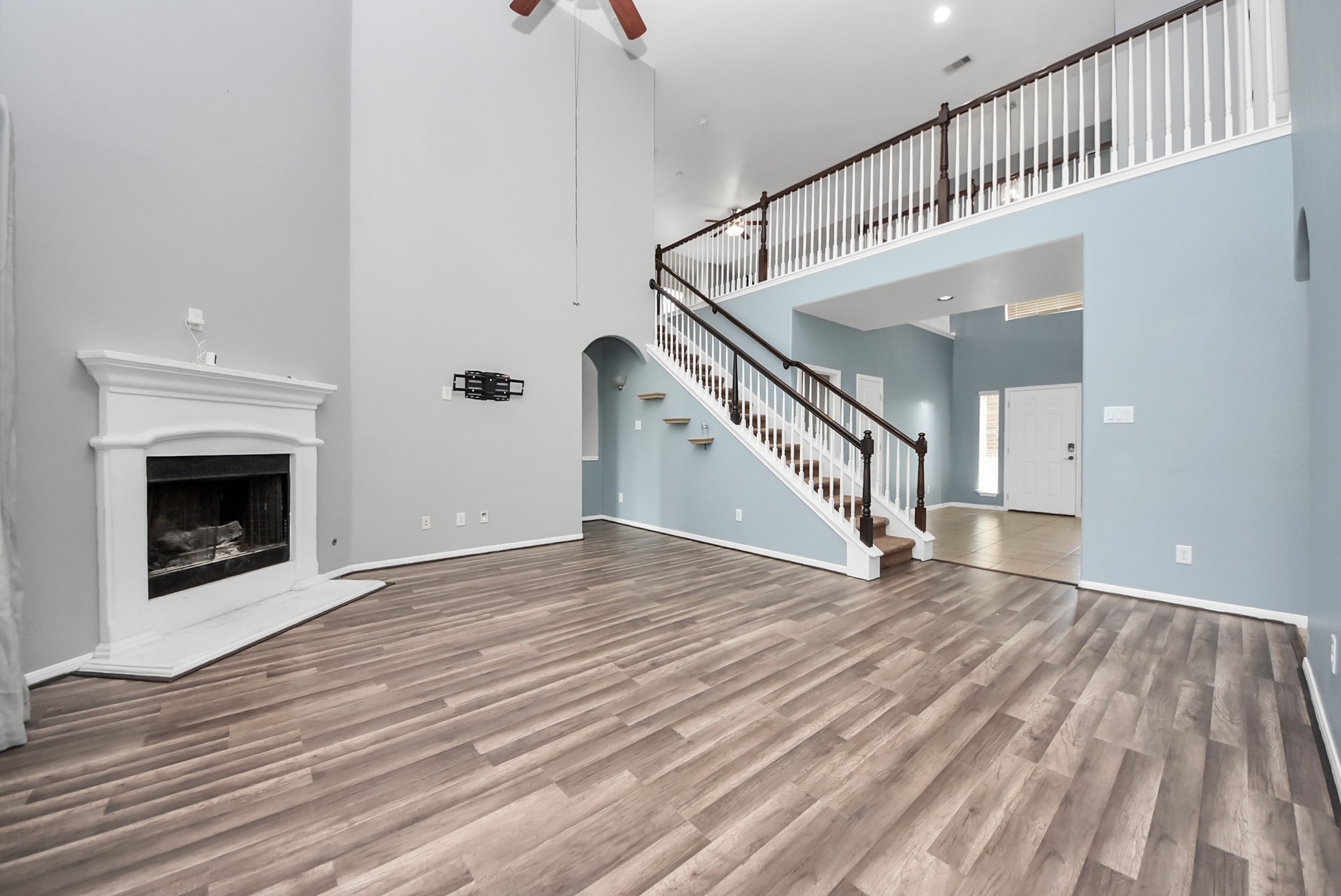 33227 Greenfield Forest Drive Spring, TX 77382 - Photo 22 of 50 a view of a livingroom with wooden floor and staircase