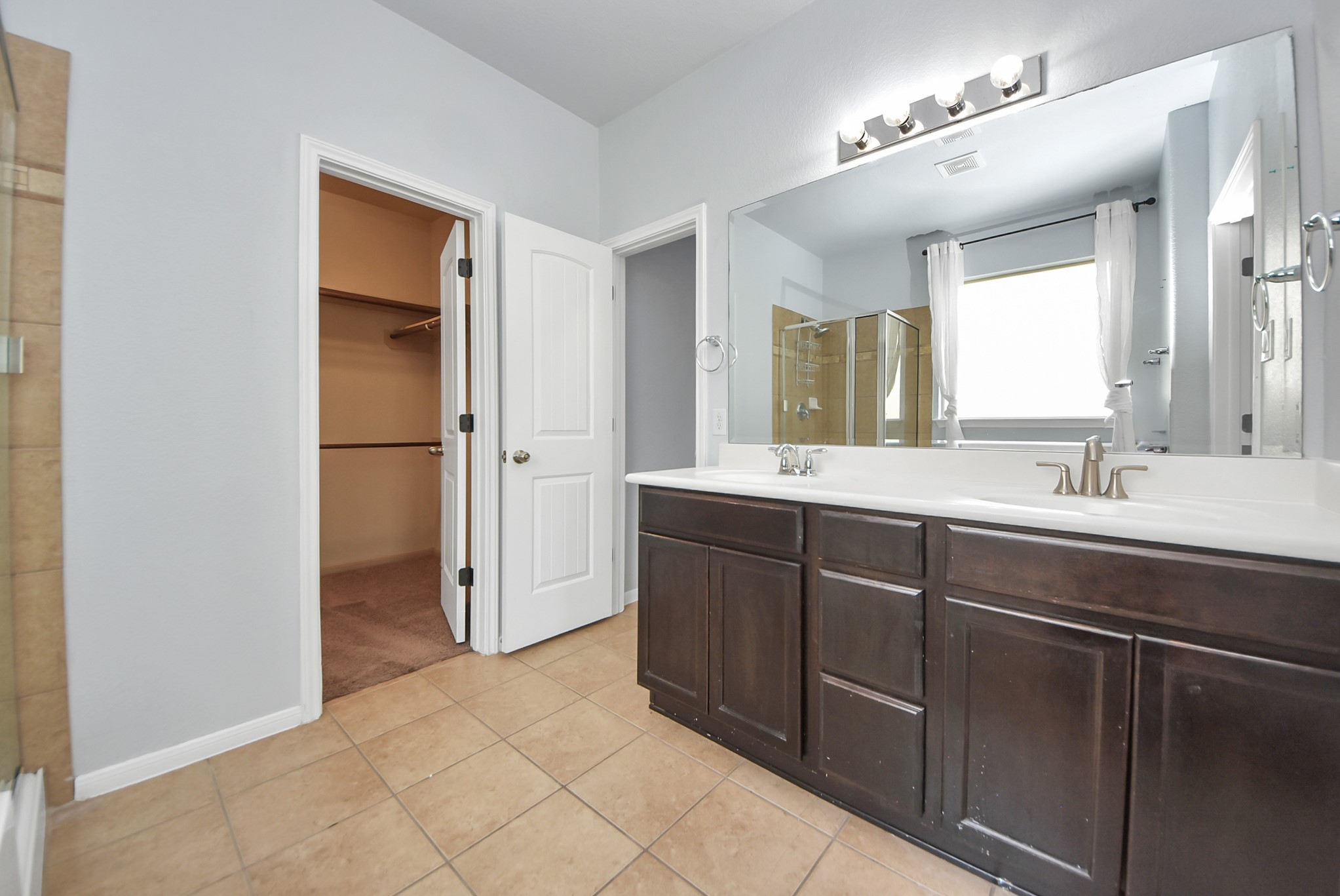 33227 Greenfield Forest Drive Spring, TX 77382 - Photo 44 of 50 a bathroom with a double vanity sink and mirror