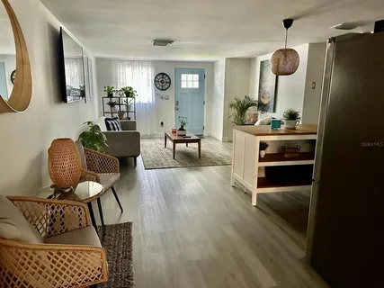 a living room with furniture and a mirror