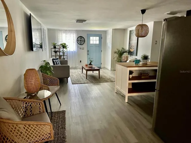 a living room with furniture and a mirror