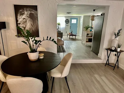 a view of a dining room with furniture and wooden floor
