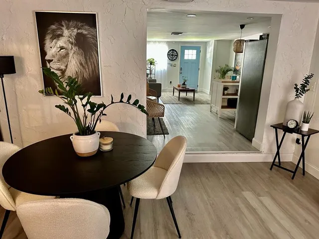 a view of a dining room with furniture and wooden floor