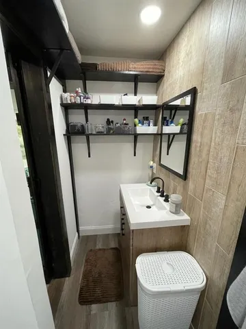 a bathroom with a toilet sink and mirror
