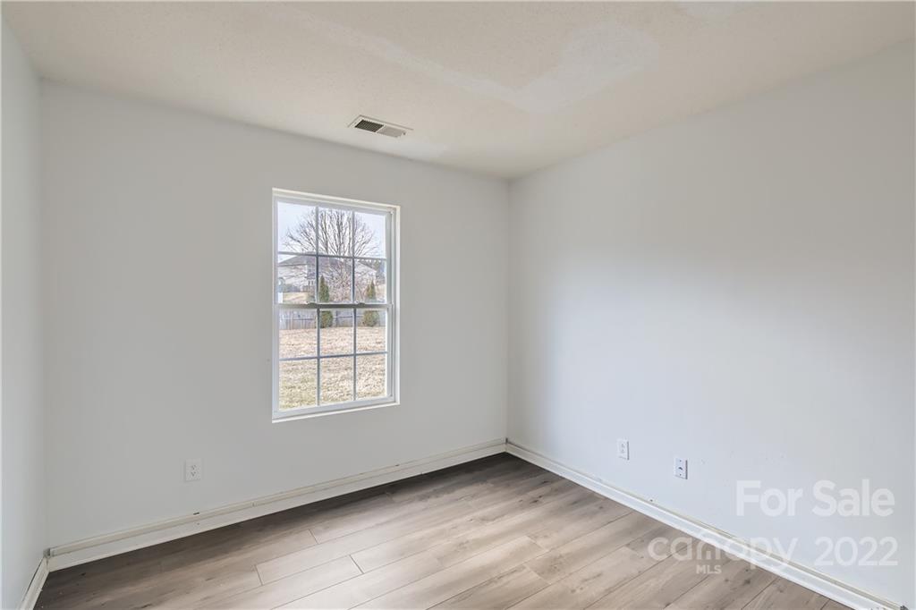 7005 Copper Ridge Court Gastonia, NC 28056 - Photo 15 of 33 an empty room with wooden floor and windows