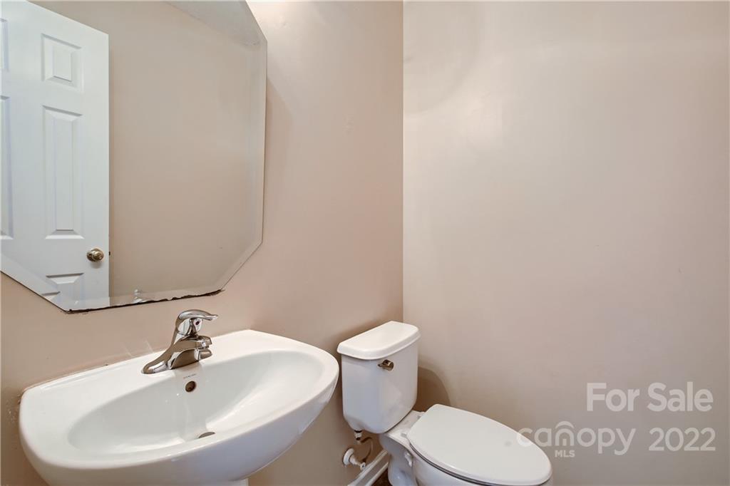 7005 Copper Ridge Court Gastonia, NC 28056 - Photo 17 of 33 a white toilet sitting next to a bathroom sink