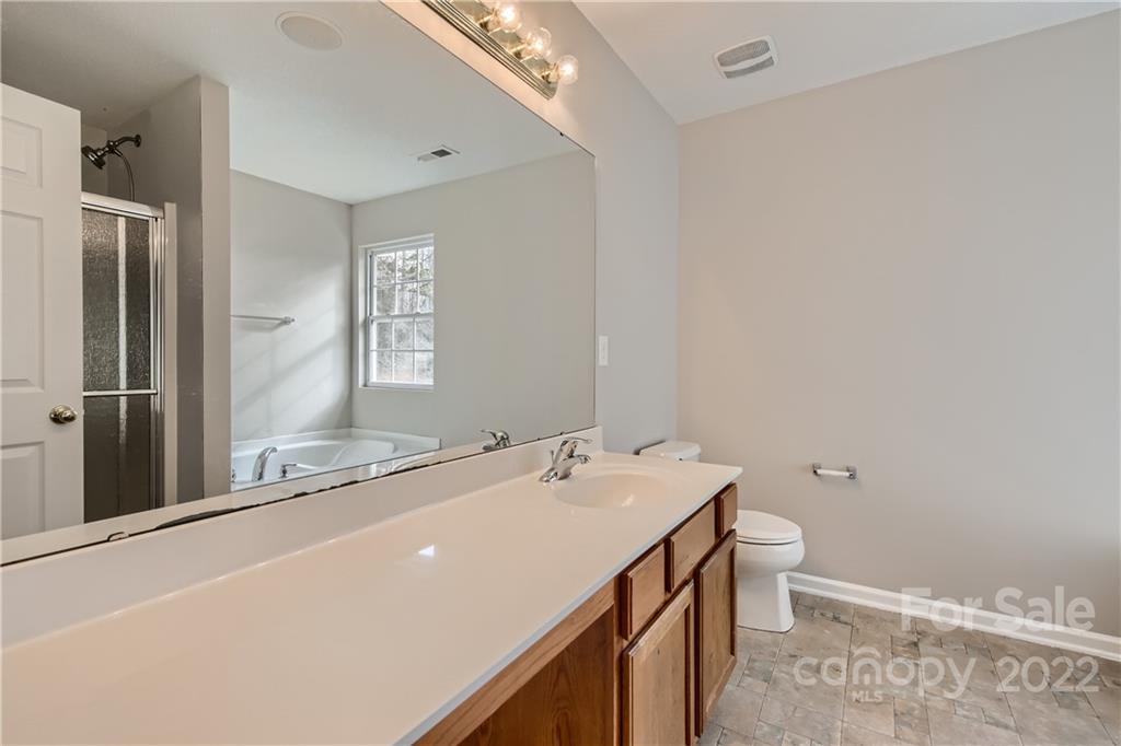 7005 Copper Ridge Court Gastonia, NC 28056 - Photo 21 of 33 a bathroom with a sink a toilet and shower