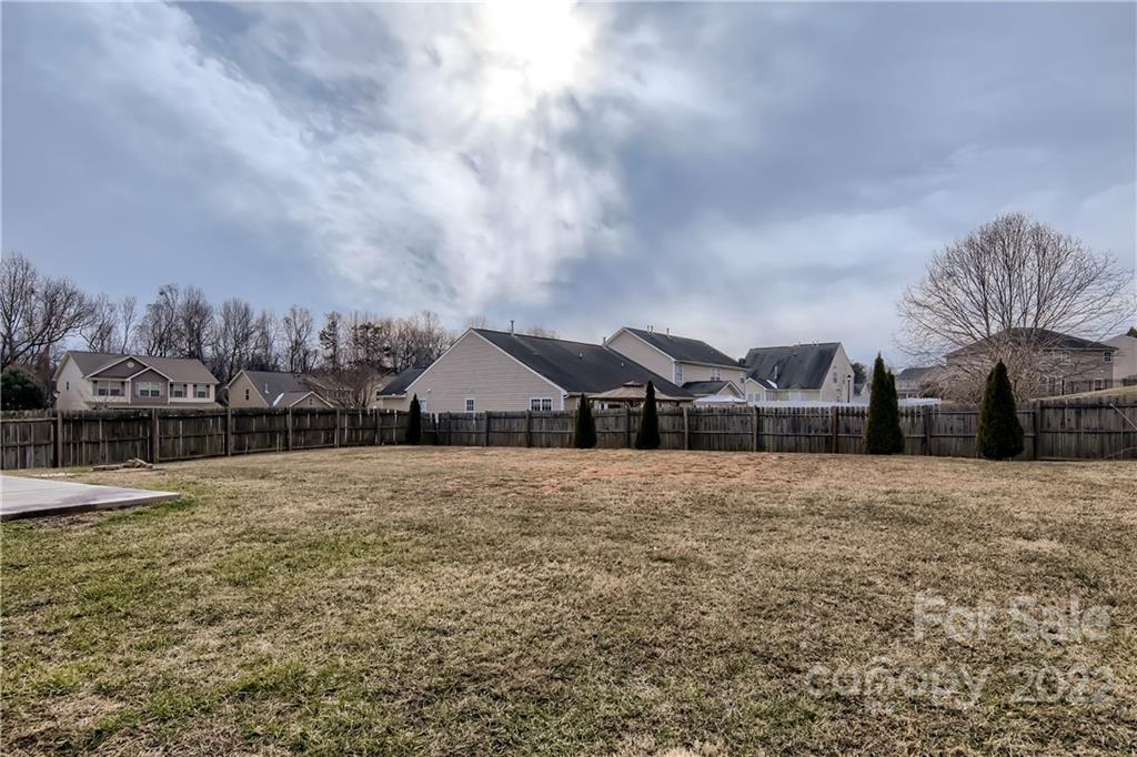 7005 Copper Ridge Court Gastonia, NC 28056 - Photo 32 of 33 a large house with a big yard and large trees