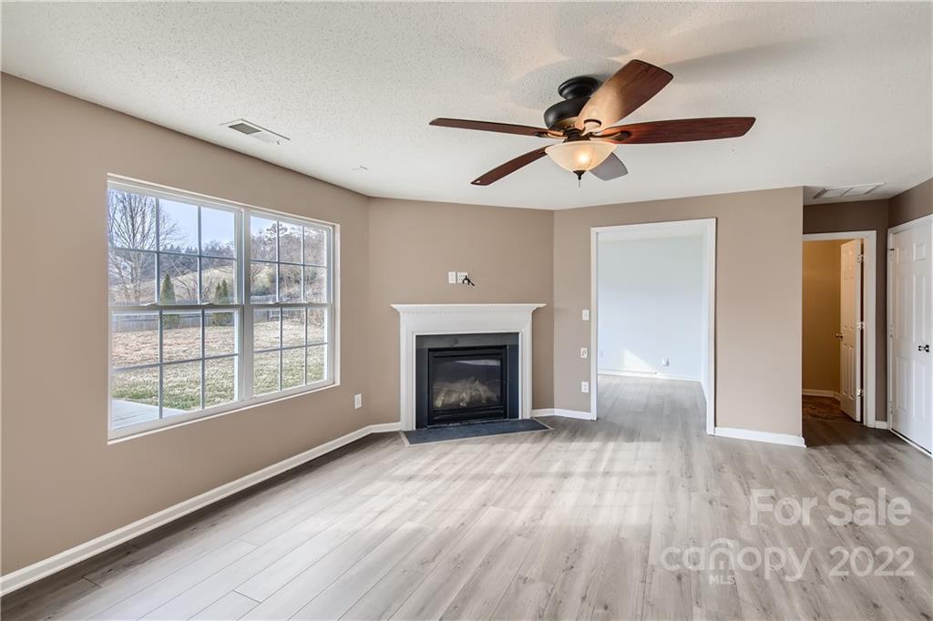 7005 Copper Ridge Court Gastonia, NC 28056 - Photo 4 of 33 a view of an empty room with a window and fireplace