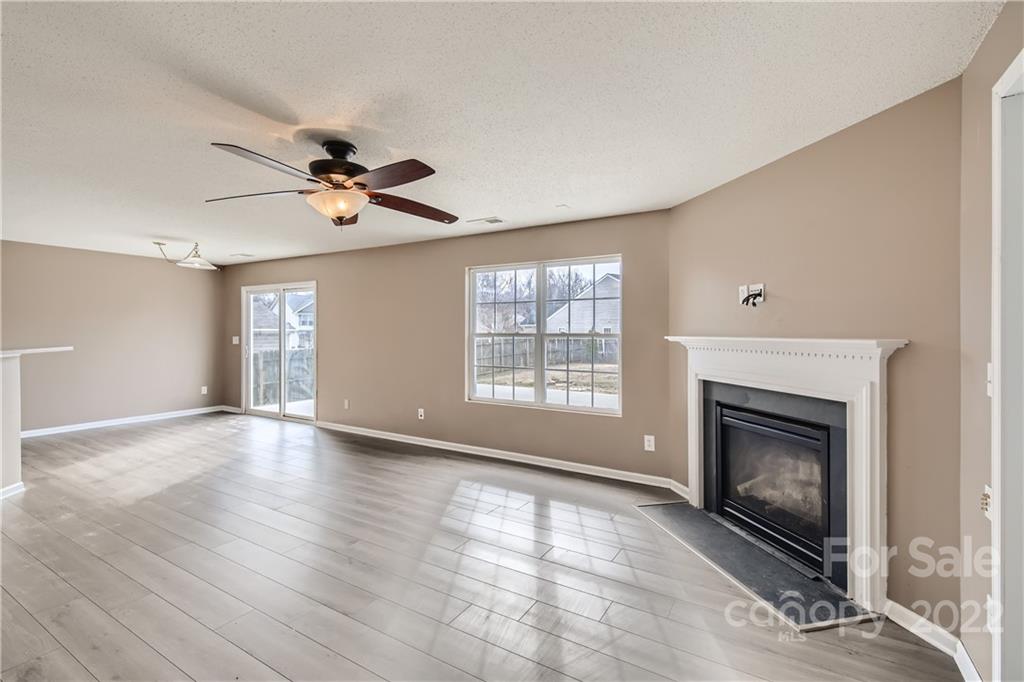 7005 Copper Ridge Court Gastonia, NC 28056 - Photo 5 of 33 a view of an empty room with a fireplace and a window