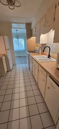 a kitchen with granite countertop a sink and a stove top oven