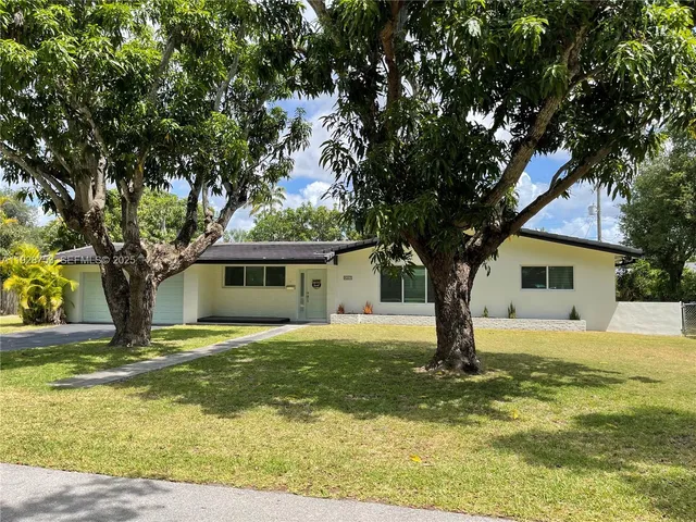 a house that has a tree in front of it