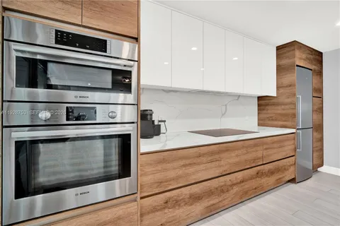 a kitchen with stainless steel appliances granite countertop a stove microwave and oven