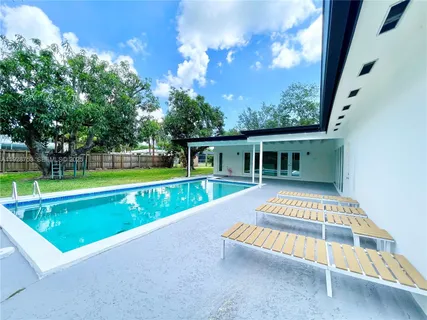a view of swimming pool with a yard