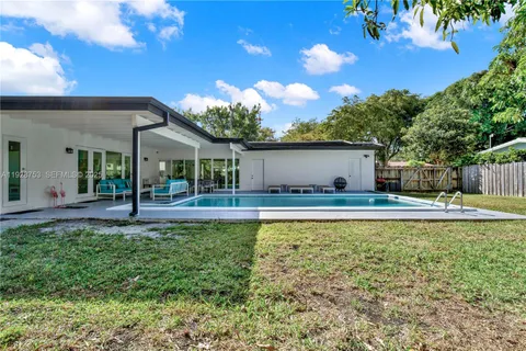 a view of a house with pool and a garden