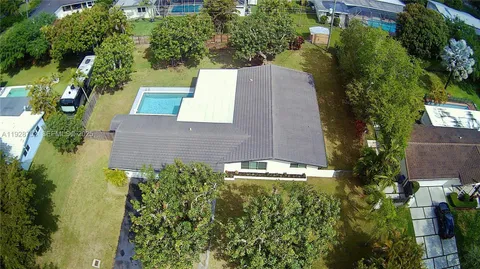 an aerial view of house with yard swimming pool and outdoor seating