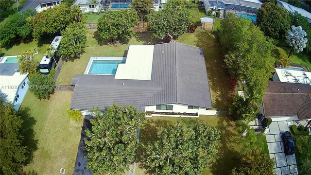 an aerial view of house with yard swimming pool and outdoor seating