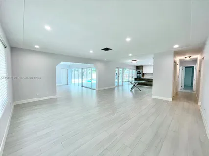 a view of kitchen with refrigerator and window