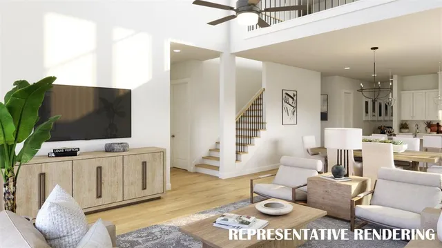 a view of living room with stainless steel appliances granite countertop couches a fireplace with wooden floor