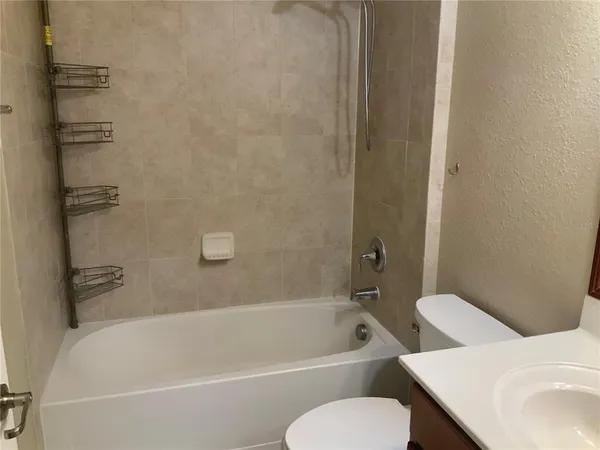 a bathroom with a toilet and a bath tub
