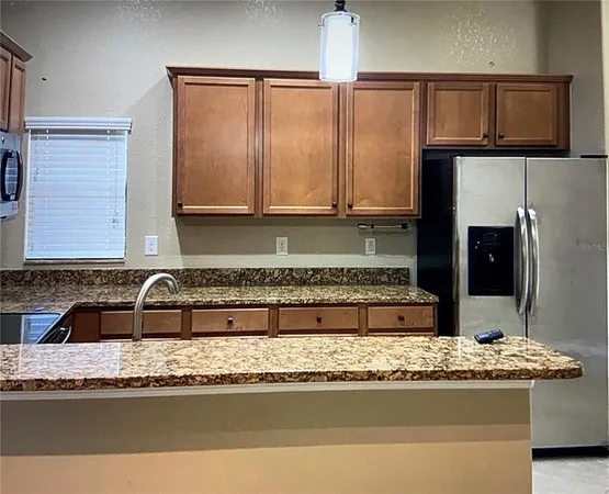 a view of a kitchen with granite countertop a sink and a stove