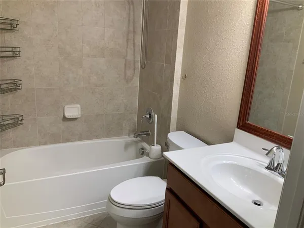 a bathroom with a sink a toilet and bathtub