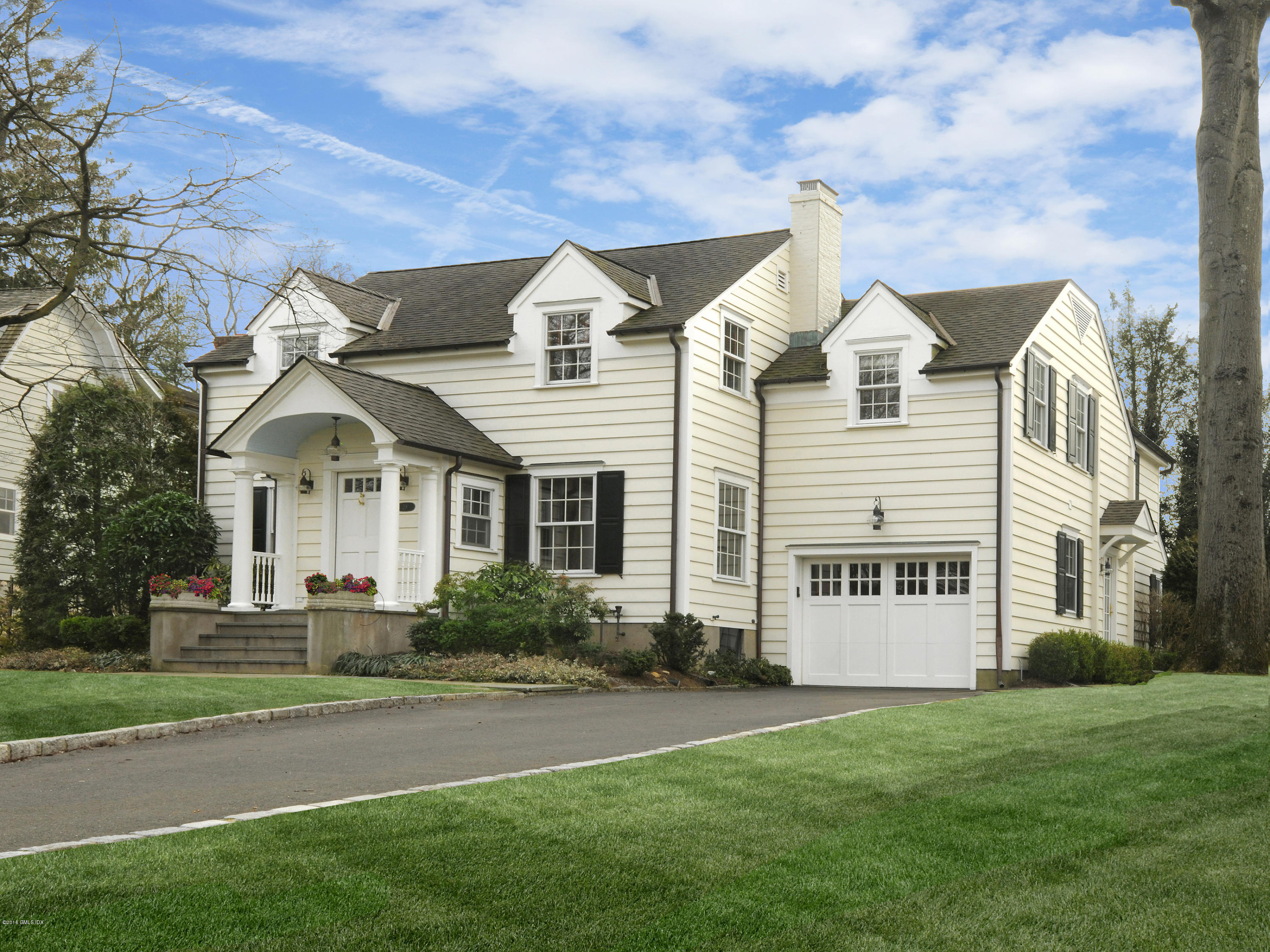 28 Lake Drive Riverside, CT 06878 - Photo 1 of 24 a view of a white house with a big yard and large trees