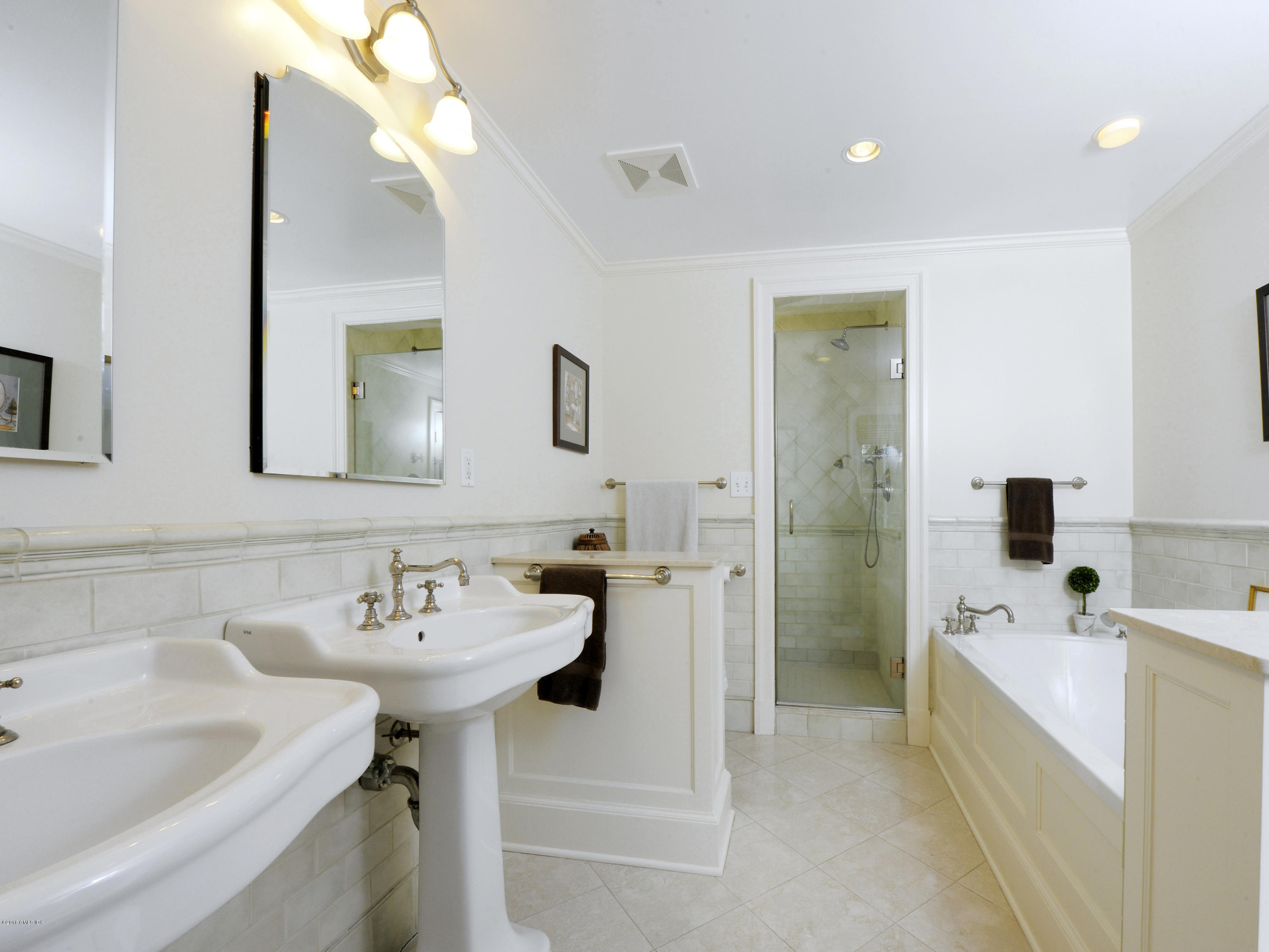 28 Lake Drive Riverside, CT 06878 - Photo 16 of 24 a bathroom with a sink a tub and a mirror