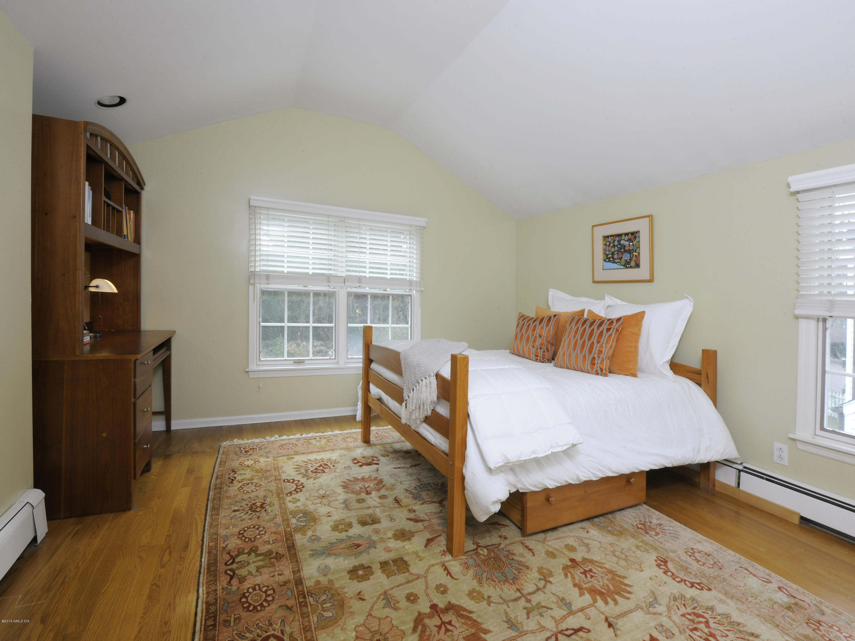 28 Lake Drive Riverside, CT 06878 - Photo 19 of 24 a bedroom with a bed and wooden floor