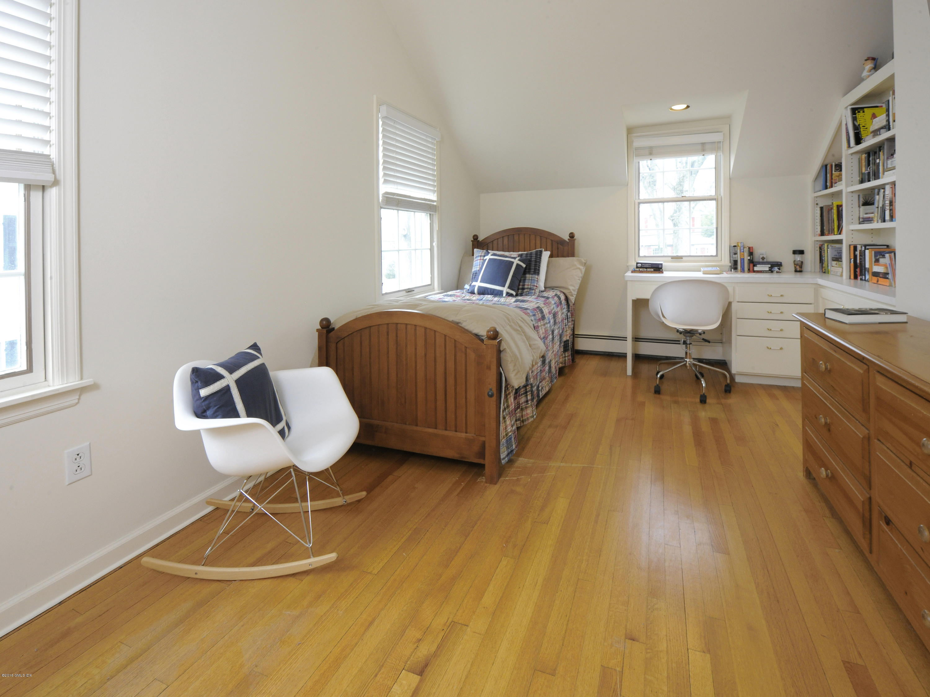 28 Lake Drive Riverside, CT 06878 - Photo 20 of 24 a bedroom with a bed and a chair