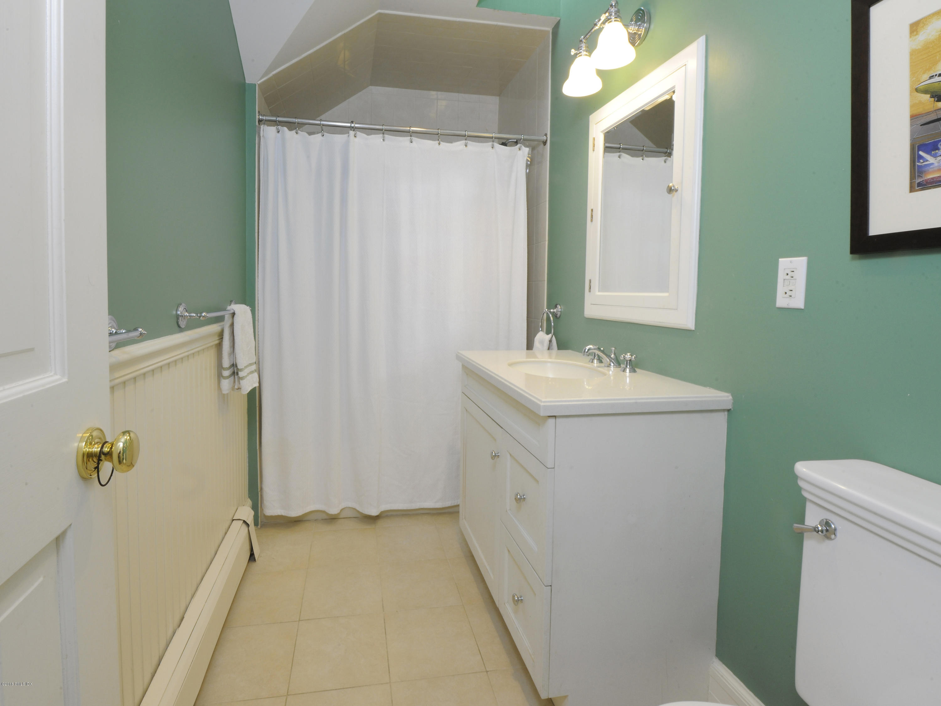 28 Lake Drive Riverside, CT 06878 - Photo 21 of 24 a bathroom with a sink a toilet and shower