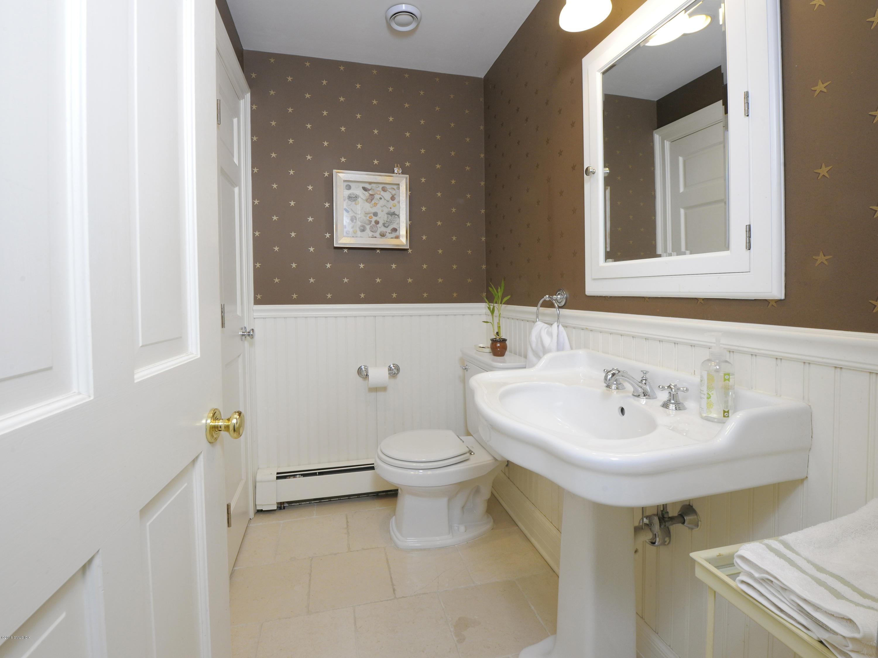 28 Lake Drive Riverside, CT 06878 - Photo 22 of 24 a bathroom with a sink a toilet and mirror